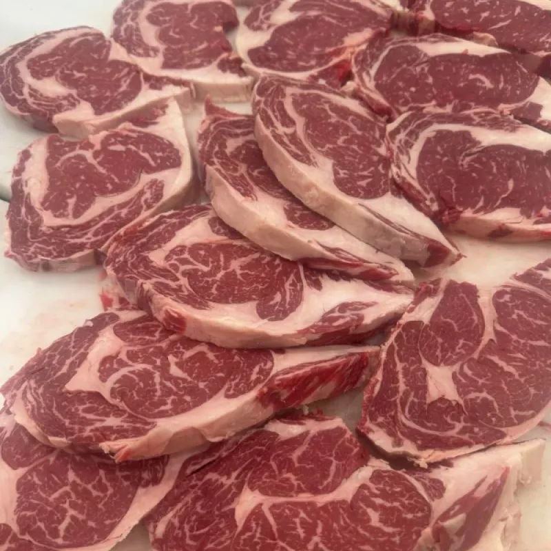 Fresh cut ribeye steaks ready for the grill.